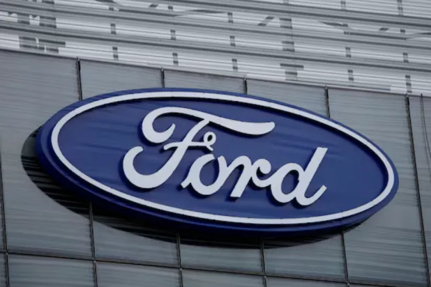 The blue Ford oval logo is displayed on the new Ford World Headquarters in Dearborn, Michigan, US November 16, 2025. REUTERS/Rebecca Cook 