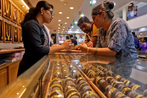 People shop for gold ornaments at a jewellery showroom during Dhanteras, a Hindu festival associated with Lakshmi, the goddess of wealth, in Mumbai, India, October 22, 2022. REUTERS/Niharika Kulkarni