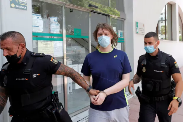 22-year-old British citizen Joseph James O'Connor is lead by Spanish police officers as he leaves a court after being arrested in connection with an alleged July 2020 Twitter hack which compromised the accounts of high-profile politicians and celebrities, according to the US Justice Department, in Estepona, Spain, July 22, 2021. REUTERS/Jon Nazca 