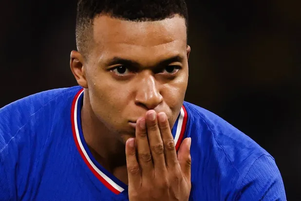 France's forward #10 Kylian Mbappe blows a kiss as he celebrates after scoring his team first goal during the 2026 World Cup qualifiers Europe zone group D football match between France and Ukraine at the Parc des Princes stadium in Paris, on November 13, 2025. (AFP)