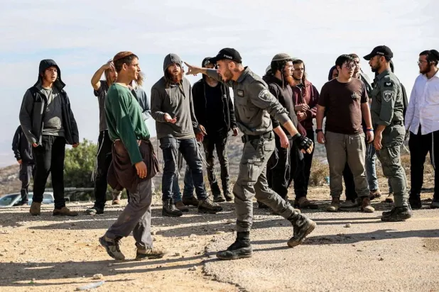 Israeli border police and a protester argue as Tzur Misgavi, an unauthorized Israeli settler outpost, is dismantled by Israeli security forces, in the Israeli-occupied West Bank, November 17, 2025. (Reuters) 