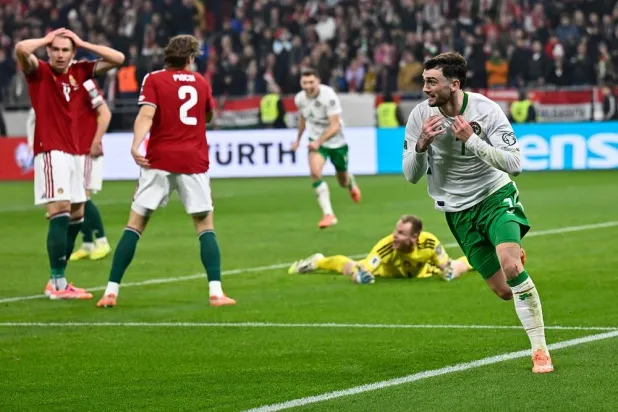 Ireland's Troy Parrott, right, celebrates after scoring his side's third goal during the World Cup 2026 group F qualifying soccer match between Hungary and Ireland in Budapest, Hungary, Sunday, Nov. 16, 2025. (AP)