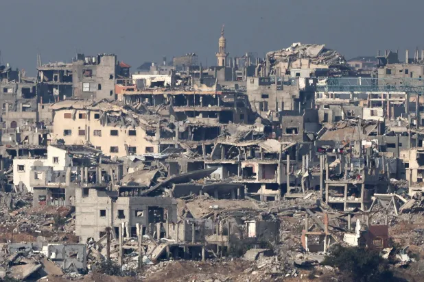 The ruins of damaged buildings in the Bureij area of the Gaza Strip as seen from the border in southern Israel, 18 November 2025, amid a ceasefire between Israel and Hamas. (EPA)