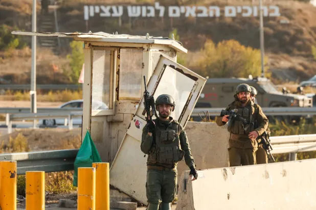 Israeli soldiers secure the site of a reported attack at the Gush Etzion Junction, in the Israeli-occupied West Bank, on November 18, 2025. (AFP)