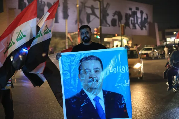 12 November 2025, Iraq, Baghdad: A supporter of Iraqi Prime Minister Mohammed Shia al-Sudani celebrates in Tahrir Square, following the announcement of preliminary election results in Baghdad. (dpa) 