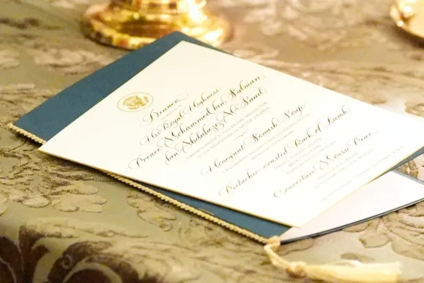 A menu is seen on a table as President Donald Trump speaks during a dinner with Prince Mohammed bin Salman, Saudi Crown Prince and Prime Minister, in the East Room of the White House, Tuesday, Nov. 18, 2025, in Washington. (AP) 