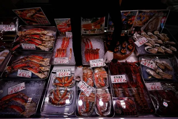 A vendor arranges seafood for sale at Tsukiji Outer Market in Tokyo, Japan, August 12, 2024. (Reuters)