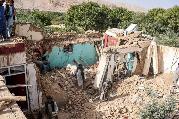 Earthquake survivors search through the remains of a damaged house in Tashqurghan in the Khulm district of Samangan province in Afghanistan. (AFP) 