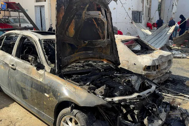 Paramedics and people gather near damaged cars at the site of the Israeli strike that killed several people yesterday night, according to the Lebanese Health Ministry, inside the Ain al-Hilweh Palestinian refugee camp in the southern city of Sidon, Lebanon, November 19, 2025. (Reuters)