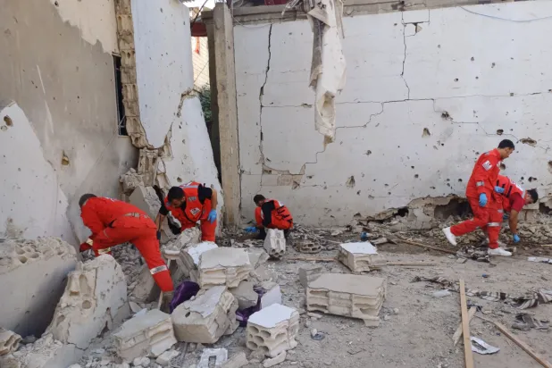 Palestinian rescue workers collect body remains at the scene where an Israeli strike on Tuesday night hit the Ein el-Hilweh Palestinian refugee camp, in the southern port city of Sidon, Lebanon, Wednesday, Nov. 19, 2025. (AP Photo/Mohammed Zaatari)