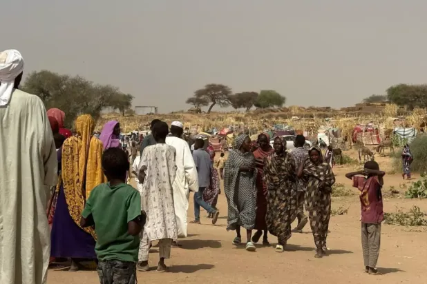 People who fled the Zamzam camp for the internally displaced walk in a makeshift encampment in an open field near the town of Tawila in war-torn Sudan's western Darfur region on April 13, 2025. © AFP
