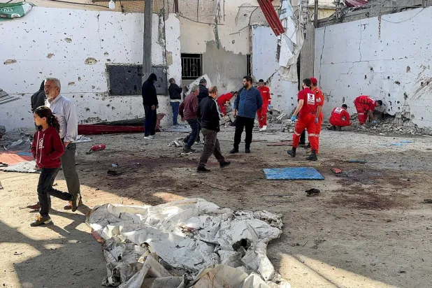 Paramedics at the site of a Tuesday night Israeli strike in Ain al-Hilweh camp in Sidon (Reuters)