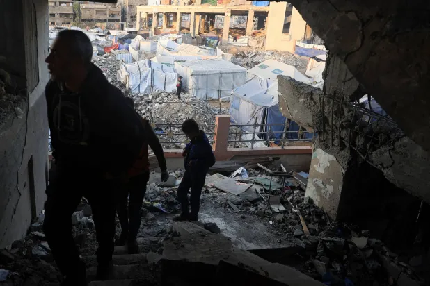 Palestinians inspect the site of Wednesday's Israeli strike in Gaza City, November 20, 2025. REUTERS/Dawoud Abu Alkas