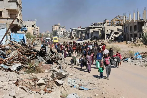 Displaced Palestinians fleeing Israeli military operations in Beit Lahia in the northern Gaza strip walk along the Salah al-Din main road in eastern Gaza City making their way to the city center, on October 22, 2024, amid the ongoing war in the Palestinian territory between Israel and Hamas. (AFP)
