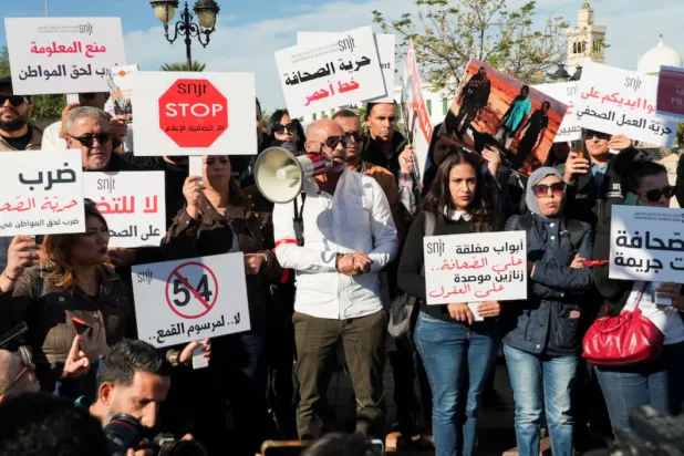 Tunisian journalists rally near the government's office, holding signs to protest press restrictions- REUTERS/Jihed Abidellaoui 