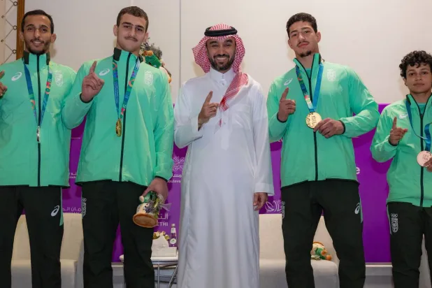 الأمير عبد العزيز الفيصل متوسطاً أبطال فريق السعودية للجوجيتسو (الشرق الأوسط)