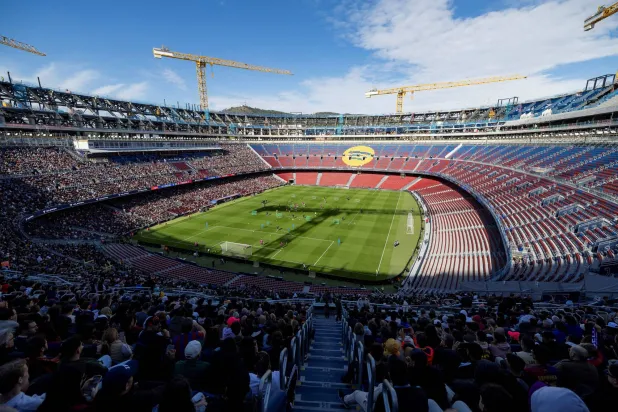 (FILES) Barcelona supporters attend FC Barcelona open training session, the first at the Camp Nou stadium since the beginning of the construction works more than two years ago, on November 7, 2025 in Barcelona. (Photo by Josep LAGO / AFP)