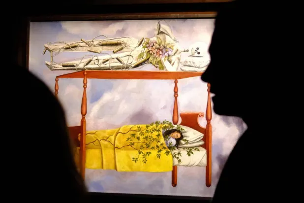 Auction house Sotheby's says Mexican artist Frida Kahlo's "El Sueno (La cama)" has sold for $54.6 million, a new record for a woman's painting. CHARLY TRIBALLEAU / AFP
