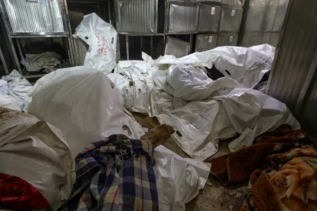 The covered bodies of Palestinians killed following Israeli airstrikes, at Al-Shifa Hospital in Gaza City, 20 November 2025. EPA/MOHAMMED SABER