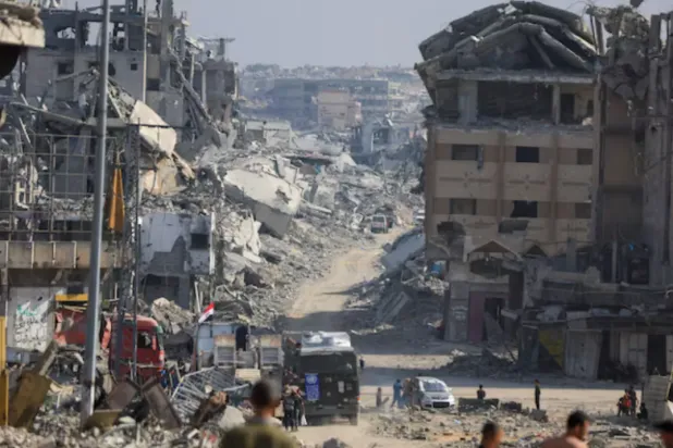 Palestinians gather as Red Cross personnel work in an area within the so-called "yellow line" to which Israeli troops withdrew under the ceasefire, as Hamas says it continues to search for the bodies of deceased hostages seized during the October 7, 2023, attack on Israel, in Gaza City November 2, 2025. REUTERS/Dawoud Abu Alkas