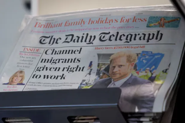 Copies of The Daily Telegraph are displayed on a rack in a supermarket in London, Britain, January 20, 2024. REUTERS/Belinda Jiao/File Photo 