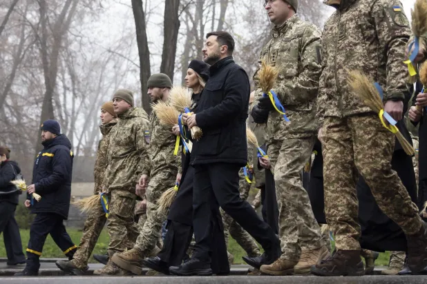 A handout photo made available by the Presidential Press Service shows Ukrainian President Volodymyr Zelenskyy (C-R), his wife Olena Zelenska (C-L) together with top officials and service members visit the Holodomor Genocide complex of the National Museum in Kyiv,  Ukraine, 22 November 2025. EPA/PRESIDENTIAL PRESS SERVICE / HANDOUT  