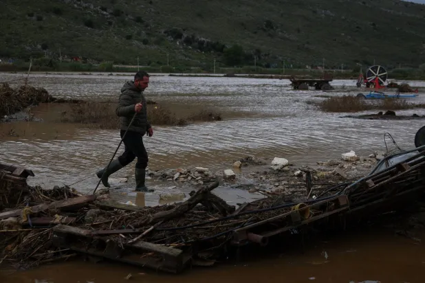 A local walks in a flooded area near Saranda, Albania, November 22, 2025. REUTERS/Florion Goga
