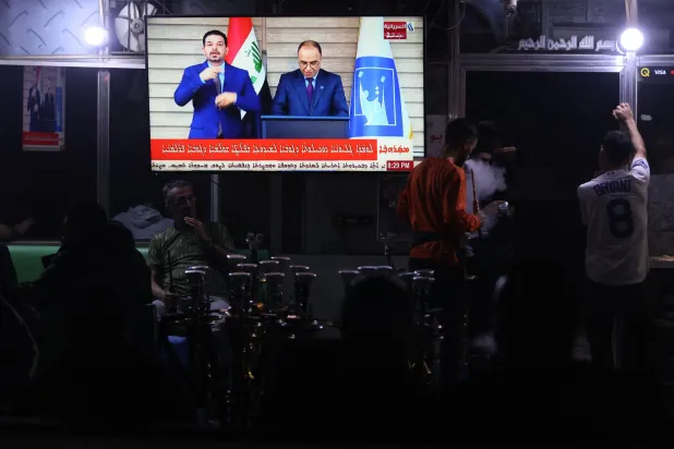 عراقيون يتابعون إعلان نتائج الانتخابات الاثنين الماضي (أ.ف.ب)