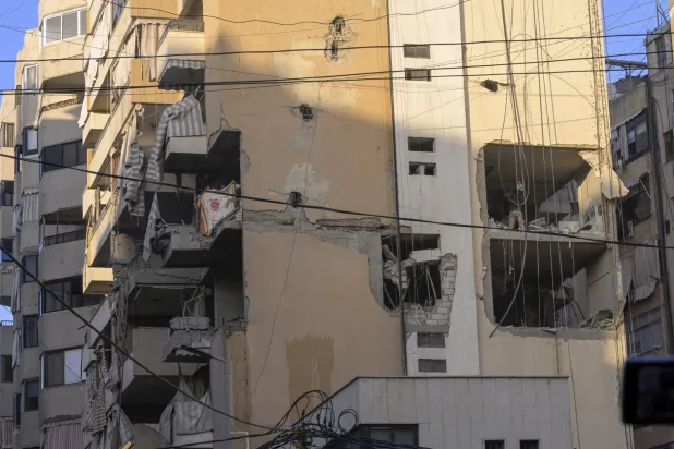 Rescuers inspect a damaged building after an Israeli airstrike on the southern suburbs of Beirut, Lebanon, 23 November 2025. (EPA)