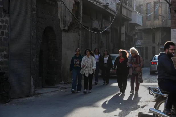 People walk through a street in the old city of Homs, Syria, Friday, Nov. 21, 2025. (AP)