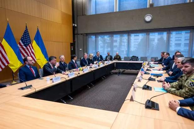 US, left, and Ukrainian, right, delegations at the beginning of their talks at the US Permanent Mission in Geneva, Switzerland, Sunday, Nov. 23, 2025. (Martial Trezzini/Keystone via AP) 