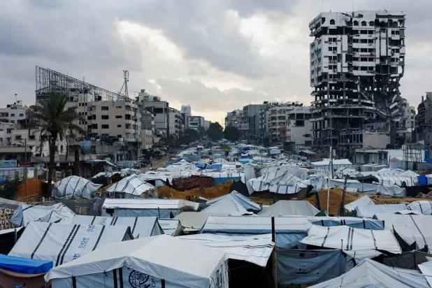 Palestinians shelter in tents on a rainy day in Gaza City, November 25, 2025. (Reuters)