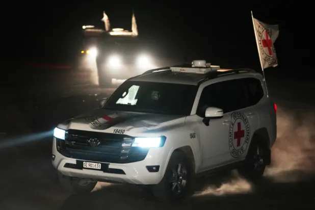 Red Cross vehicles carrying the bodies of three people believed to be deceased hostages handed over by Hamas make their way toward the border crossing with Israel, to be transferred to Israeli authorities, in Deir al-Balah, central Gaza Strip, Sunday, Nov. 2, 2025. (AP Photo/Jehad Alshrafi)