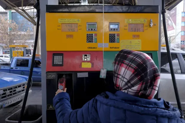 An Iranian woman puts a nozzle back after refuelling her car at a petrol station in Tehran, Iran, January 25, 2016. REUTERS/Raheb Homavandi/TIMA 