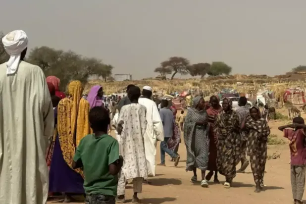 People who fled the Zamzam camp for the internally displaced walk in a makeshift encampment in an open field near the town of Tawila in war-torn Sudan's western Darfur region on April 13, 2025. © AFP
