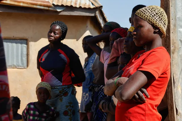 أقارب المتوفى أنتوني موسى في دوموغاري بمقاطعة بورغو بنيجيريا يوم 25 نوفمبر 2025... توفي أنتوني موسى بعد نقله إلى المستشفى إثر علمه باختطاف طفليه خلال الهجوم على مدرسة «سانت ماري»... (إ.ب.أ)