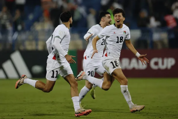 Football - FIFA Arab Cup - Qatar 2025 - Qualifying - Palestine v Libya - Thani bin Jassim Stadium, Al Rayyan, Qatar - November 25, 2025 Palestine's Oday Dabbagh and Ahmad Al Qaq celebrate after winning the penalty shootout. (Reuters)