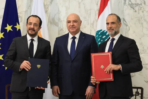 Cyprus' President Nikos Christodoulides and Fayez Rasamny, Lebanese Minister of Public Works and Transport, hold the maritime demarcation agreement documents after signing it, alongside Lebanese President Jospeh Aoun, at the presidential palace in Baabda, Lebanon November 26, 2025. (Reuters) 