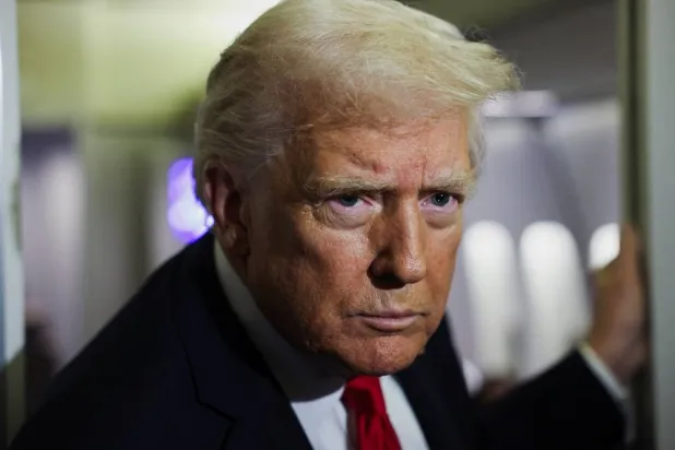 US President Donald Trump looks on aboard Air Force One during travel to Palm Beach, Florida, from Joint Base Andrews, Maryland, US, November 25, 2025. (Reuters)