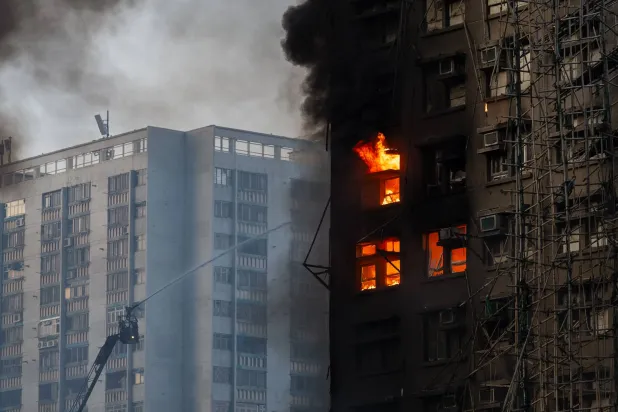 Firefighters work the scene of a fire at Wang Fuk Court, a residential estate in the Tai Po district of Hong Kong's New Territories, on Wednesday, Nov. 26 2025. (AP Photo/Chan Long Hei)