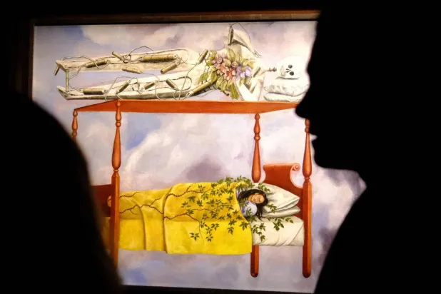 Auction house Sotheby's says Mexican artist Frida Kahlo's "El Sueno (La cama)" has sold for $54.6 million, a new record for a woman's painting. CHARLY TRIBALLEAU / AFP
