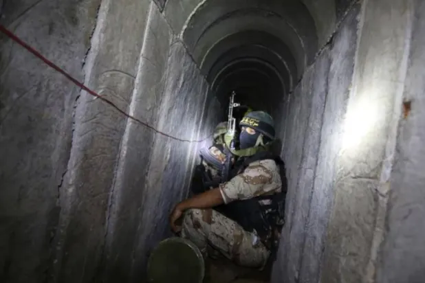A Palestinian fighter from the Islamic Jihad's armed wing, the Al-Quds Brigades, is seen in a tunnel in the south of the Gaza Strip (AFP)
