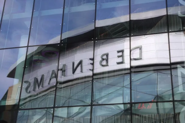 FILE PHOTO: A Debenhams store is reflected on a glass as it closes down, in Newcastle, Britain, May 15, 2021. REUTERS/Lee Smith/File Photo