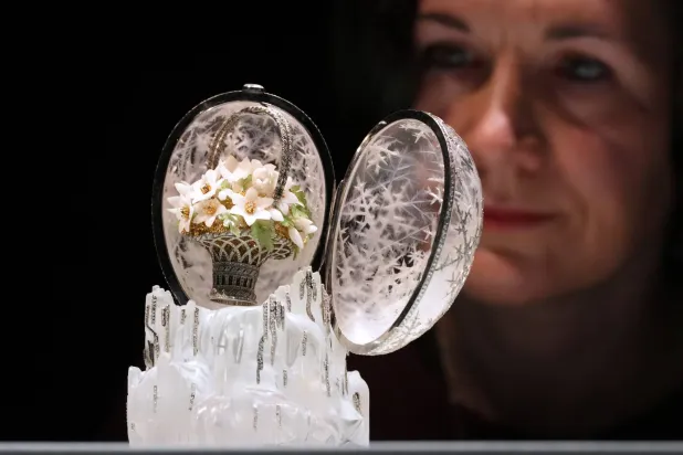 Head of Department Margo Organesian looks towards the Winter Egg by Faberge as it is displayed at Christie's auction rooms in London, Thursday, Nov. 27, 2025. (AP Photo/Kirsty Wigglesworth)