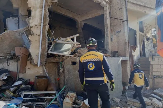  This photo provided by the Syrian Civil Defense, White Helmets, Syrian Civil Defense workers check a house that was destroyed during an Israeli forces raid in the southern Syrian village of Beit Jin, Syria, Friday, Nov. 28, 2025. (Syrian Civil Defense White Helmets via AP) 