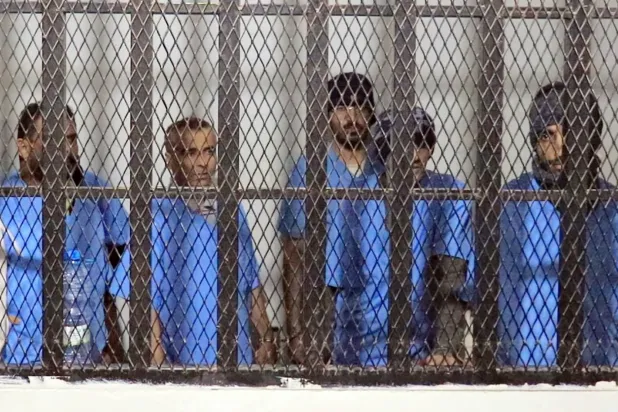 A handout photo made available by the Houthi-run Saba news agency shows defendants standing behind bars during a sentencing hearing at the state security court in Sanaa, Yemen, 22 November 2025. (EPA/ Houthi-run Saba news agency)