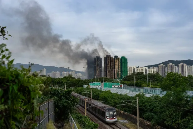 Smoke rises after a fire broke out at Wang Fuk Court, a residential estate in the Tai Po district of Hong Kong's New Territories, Thursday, Nov. 27 2025. (AP Photo/Chan Long Hei)