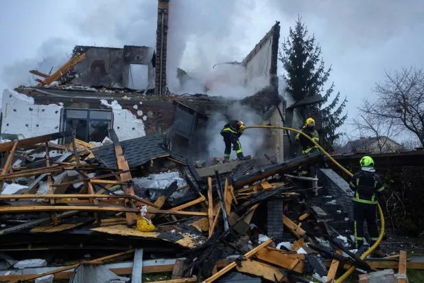 Firefighters work at the site of a private home that went up in flames after it was hit by a Russian drone during a night of attacks on Kyiv, amid Russia's attack on Ukraine, November 29, 2025. (Reuters)