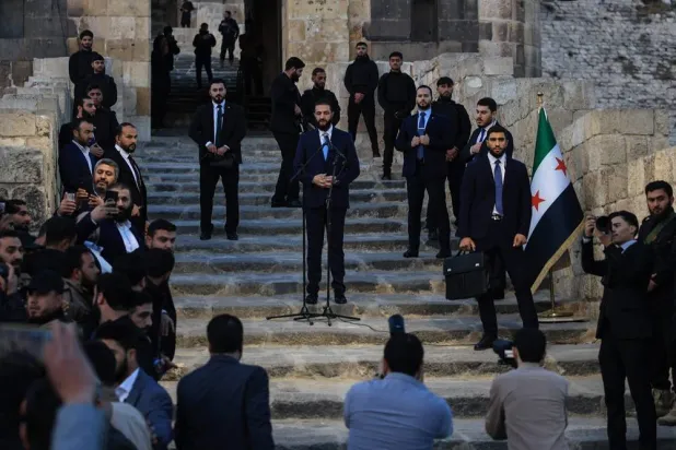 Syrian President Ahmed al-Sharaa delivers a speech at the gate of Aleppo’s citadel during celebrations marking one year since an opposition alliance, led by Sharaa, entered the northern city and swiftly took control of it, on November 29, 2025. (AFP) 