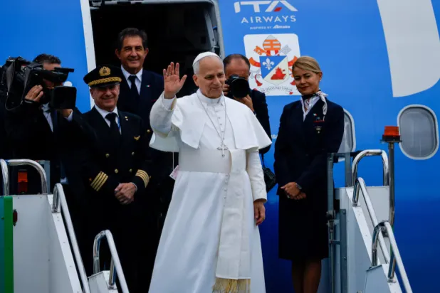 Pope Leo XIV waves while boarding the papal plane at Ataturk Airport, as he departs from Türkiye to Lebanon during his first apostolic journey, in Istanbul, Türkiye, November 30, 2025. REUTERS/Kemal Aslan 